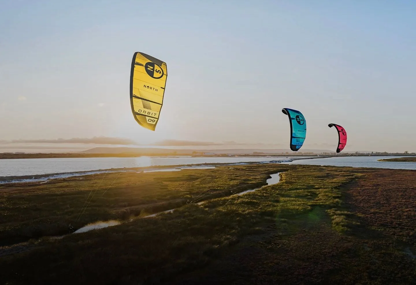 Kites flying above the coastline at a DC Kitesurfing session