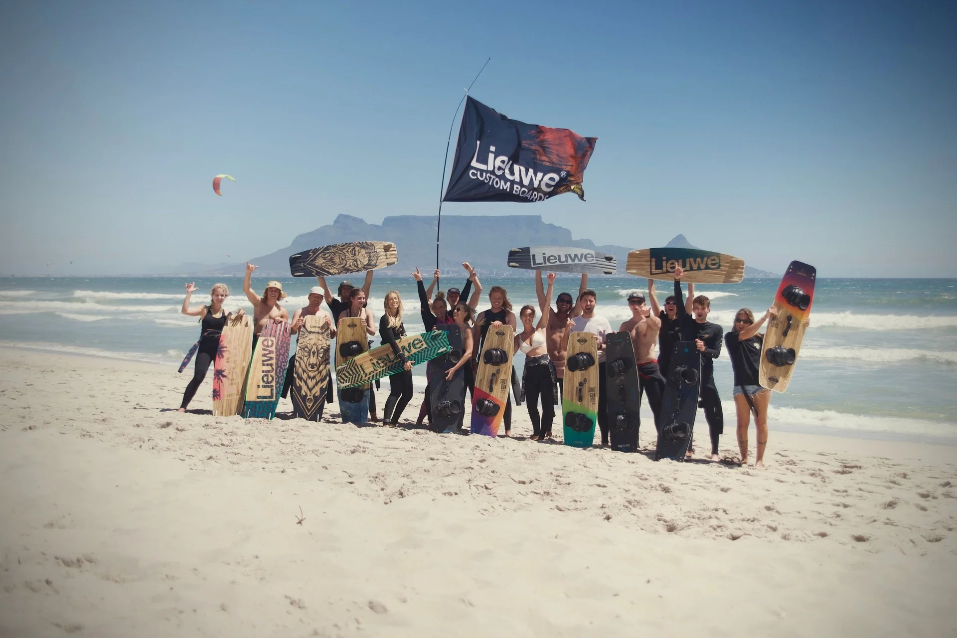 A DC kite camp group gathered on a wide sandy beach